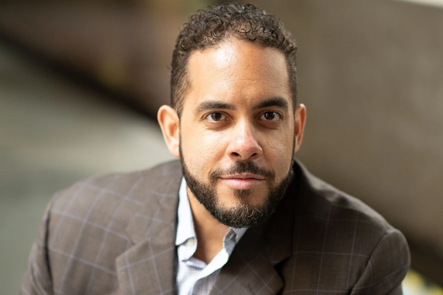 middle aged man in grey suit smiling